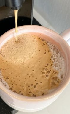 a cup filled with liquid sitting on top of a counter