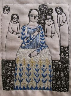 an embroidered piece with a woman and two cats