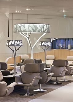 an airport lounge area with chairs and lamps