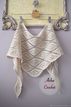 a crocheted shawl hanging on a hook