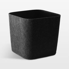 a black square container sitting on top of a white surface with no one around it