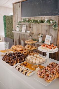 an assortment of donuts and pastries displayed on a table