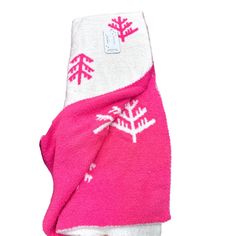 a pink and white towel with snowflakes on the front is folded up to show it's design