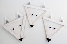 three white fox shaped magnets sitting on top of a table