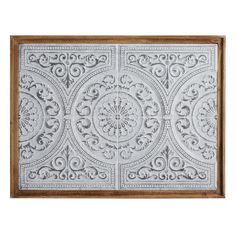 an ornately designed ceiling tile with wood frame and decorative designs on the front panel