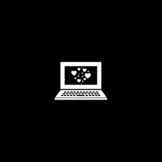 a black and white photo of a laptop with hearts coming out of the screen on it