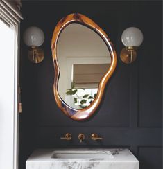 a bathroom with a marble sink and mirror