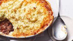 a close up of a pie on a table with spoons and utensils