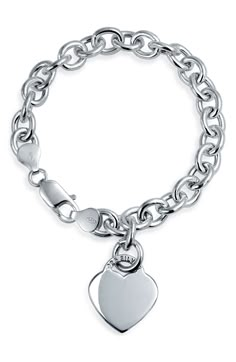 A gleaming heart charm dangles from a sterling silver chain, creating a beautiful bracelet that is the perfect gift for your sweetheart. Sterling silver chain bracelet with heart charm. Lobster clasp. Approx. 7.5" chain length. Imported Sterling Silver Heart Pendant Bracelet In White Gold, Elegant Sterling Silver Heart-shaped Charm Bracelet, White Gold Sterling Silver Heart Pendant Bracelet, Heart-shaped Sterling Silver Chain Bracelet For Anniversary, White Gold Heart Charm Chain Bracelet For Anniversary, Elegant Dangle Charm Bracelet With Heart Charm, Classic White Gold Charm Bracelet With Heart Charm, Classic White Gold Charm Bracelet With Heart, White Gold Chain Bracelet With Heart Charm For Anniversary