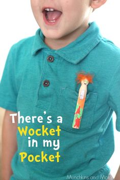 a young boy wearing a green shirt and holding a toothbrush in his pocket with the words there's a wocket in my pocket on it