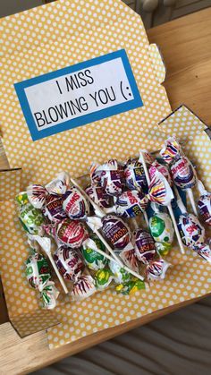 a box filled with lots of lollipops sitting on top of a table