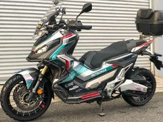 a motorcycle parked in front of a garage door