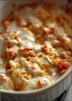 a casserole dish filled with cheese and meat