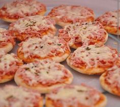 mini pizzas with cheese and sauce on a plate