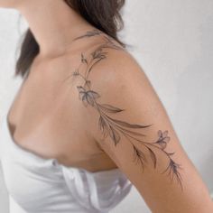 a woman with a flower tattoo on her shoulder