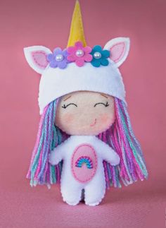 a small stuffed animal wearing a unicorn hat