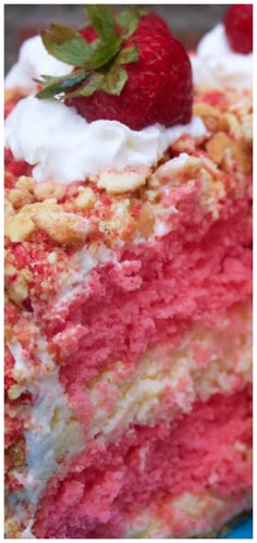 a close up of a piece of cake with strawberries on top and whipped cream