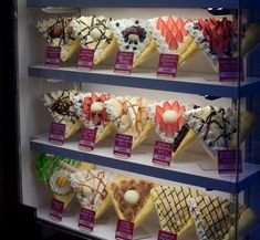 a display case filled with lots of different types of desserts