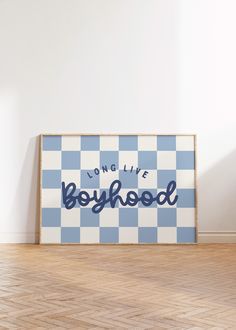 a blue and white checkered wall with the word boyhood written in cursive font