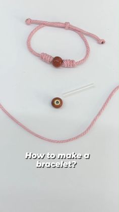 a pink cord with two beads on it and the words how to make a bracelet?