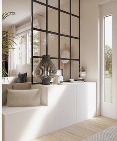 a living room filled with furniture next to a large window and potted palm tree