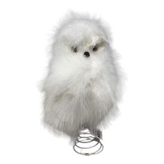 a white furry bird on a metal stand