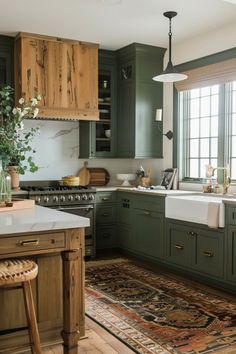 a kitchen with green cabinets and an area rug