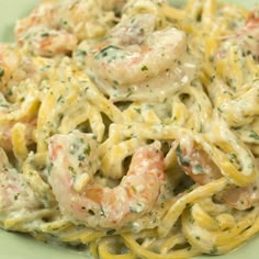 pasta with shrimp and cream sauce in a green bowl