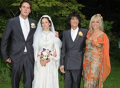 a group of people standing next to each other on a lush green field