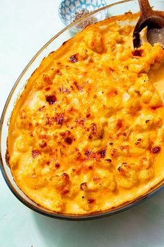 a casserole dish filled with macaroni and cheese on top of a table