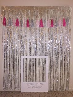 the curtain is decorated with pink and silver tassels