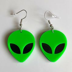 pair of green alien earrings with black eyes