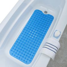 a blue bath mat sitting on top of a white bath tub