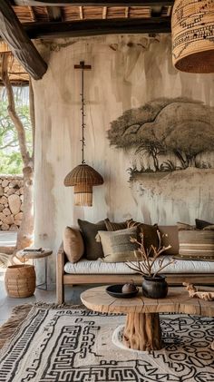 a living room filled with furniture next to a wall covered in bamboo baskets and paintings