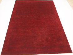 a red rug is laying on the floor