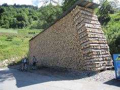 a large pile of logs sitting on top of a road