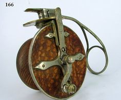 an old metal and wood object on a white background