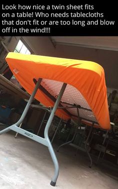 an orange tent sitting on top of a metal stand