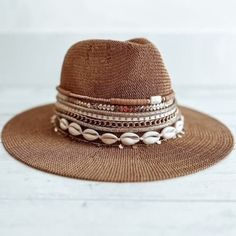 "This hat will just look so stylish with everything! Great for Festivals, beach, a day out and about A packable, knit Panama hat is perfect for your next tropical vacation! Wear it daytime to night time, with a bathing suit or a cute outfit.   Choose your initial, your name beaded on the hat, or just opt for rows of jewelry and trim.    One size fits most  Dented crown - Straw construction - Flat brim  Approx. 3\" brim/band height, 4.5\" crown height - Approx. 22.4\" inner circumference   Import Adjustable Fedora For Vacation, Vacation Bucket Hat One Size Fits Most, Brown Fedora Panama Hat For Vacation, Wide Brim Toquilla Straw Fedora For Festivals, Beachy Short Brim Fedora For Beach Season, Adjustable Brimmed Panama Hat For The Beach, Adjustable Brimmed Panama Hat For Beach, Adjustable Toquilla Straw Fedora For Beach, Adjustable Brimmed Beachy Panama Hat