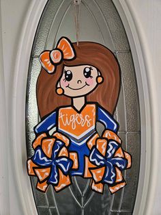 a stained glass window depicting a girl with orange hair and blue outfit holding a football