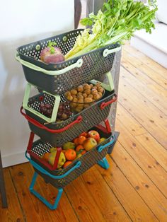 three baskets stacked on top of each other with fruits and vegetables in the bottom basket