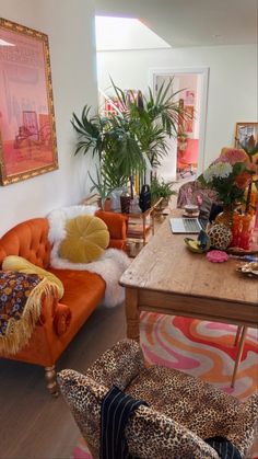 a living room filled with lots of furniture next to a table and potted plants