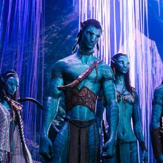 the blue man group from avatar is standing in front of an ice cave with waterfalls