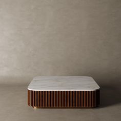 a marble and wood coffee table against a wall