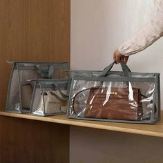 a person holding two bags on top of a shelf