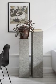 a table and chairs in a room with white walls