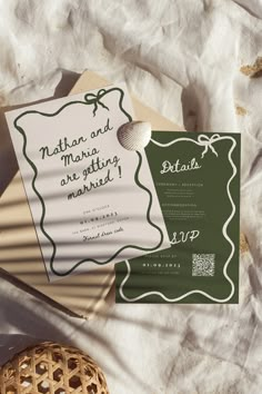 the wedding stationery is laid out on top of the paper and next to an egg