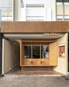 an entrance to a building with wooden doors