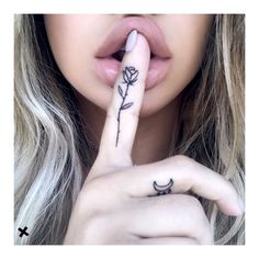 a woman with her finger tattoo on it