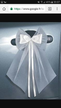 a white bow tied to the side of a car door